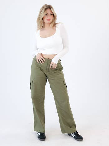 Model wearing the green cargo pants