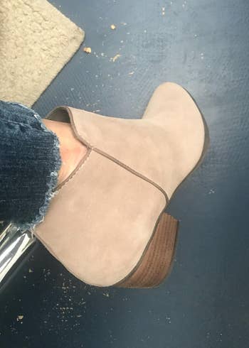 reviewer wearing the same boots in sand suede color