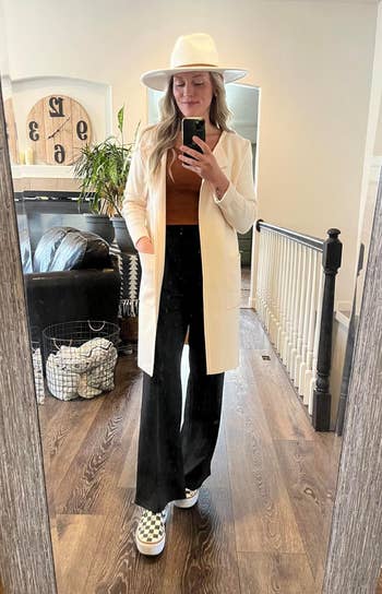 reviewer in a long white open front coat 