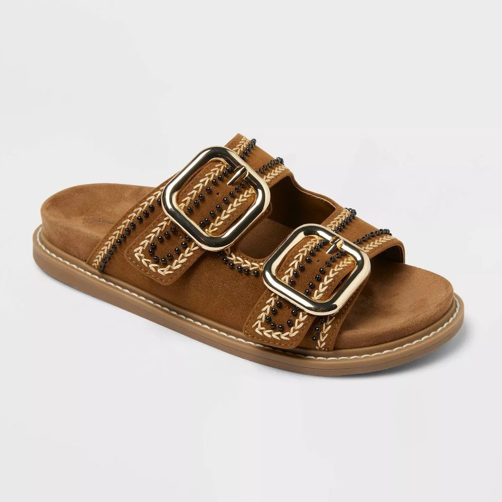 Brown sandal with thick sole, large buckles, and decorative stitching detail
