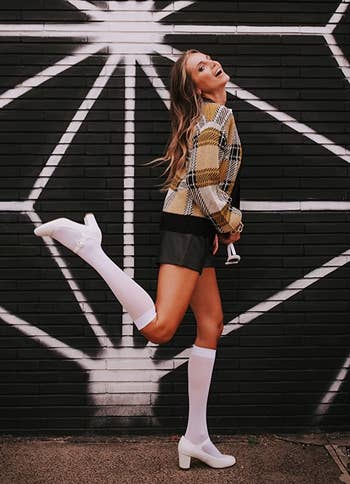 reviewer wearing the white mary janes with knee socks
