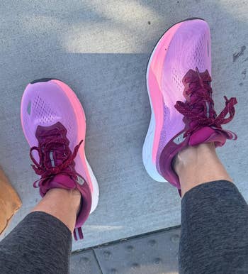 reviewer wearing the hot pink shoes
