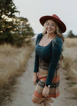 Reviewer wearing the green long sleeve bodysuit with a skirt
