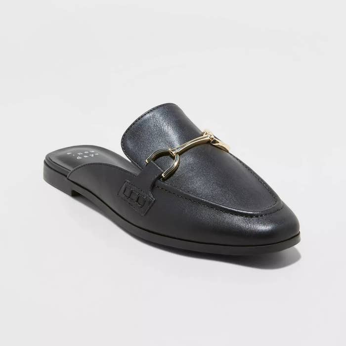 Black leather slip-on loafer with a gold metal bit detail on top