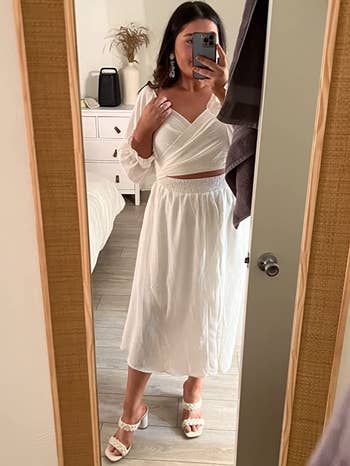 reviewer wearing the white dress with the crossover design in front