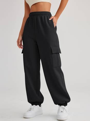 Person wearing black high-waisted cargo sweatpants 