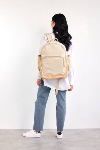 model wearing the white backpack