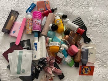 reviewer pic of all their products in a pile on a bed