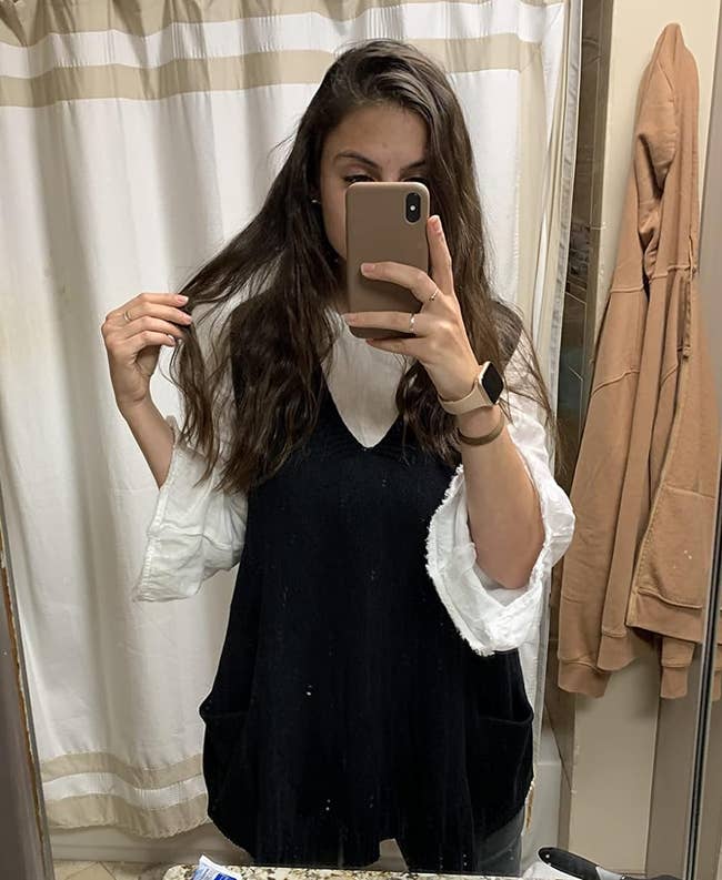 Reviewer wearing the black sweater vest