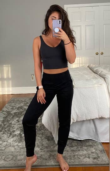 Reviewer in black high waisted leggings with cuffed ankles 