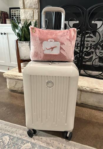 The folded up blanket mounted on a suitcase