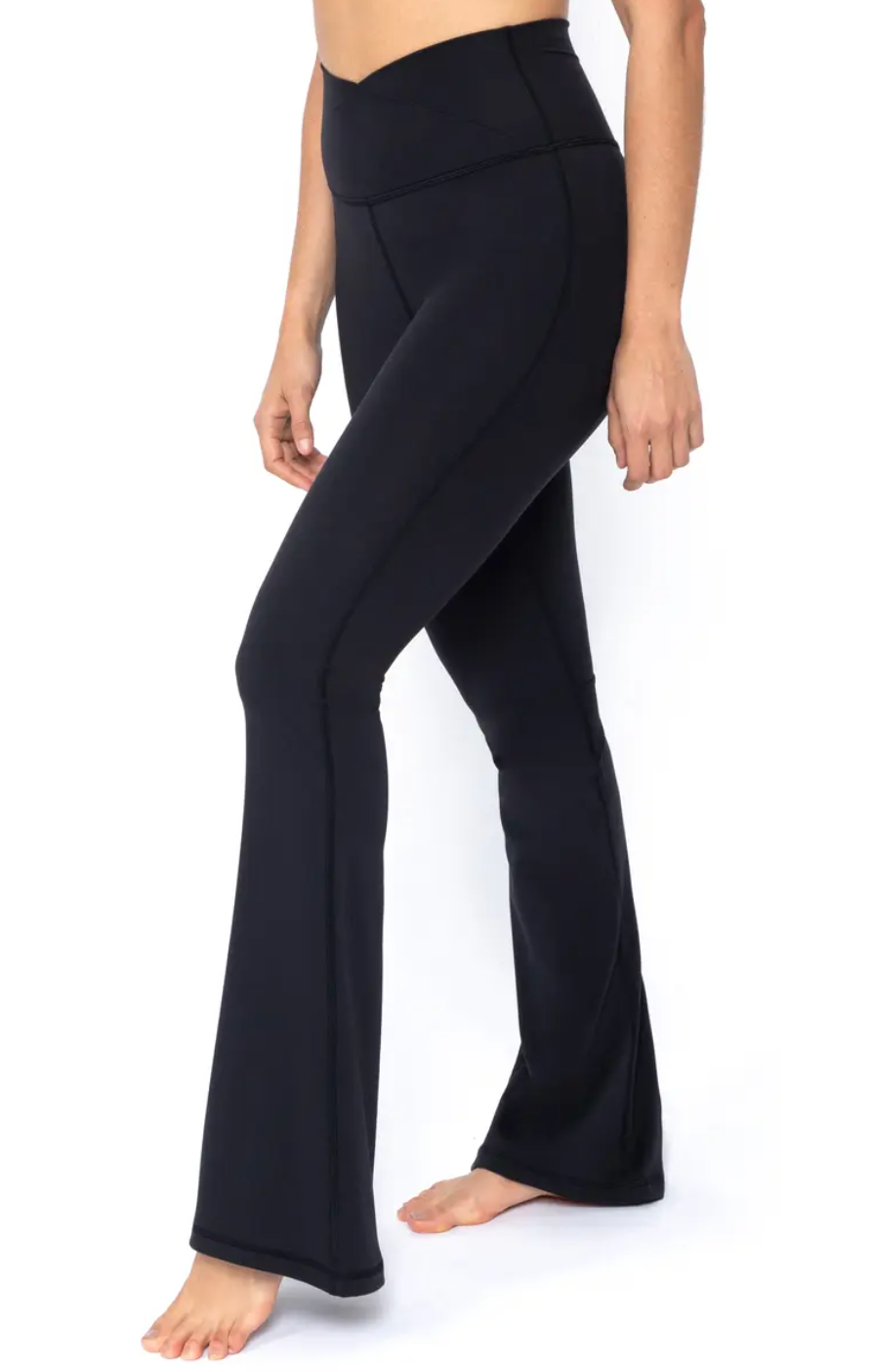 Person modeling flared yoga pants, highlighting fit and style; no shoes