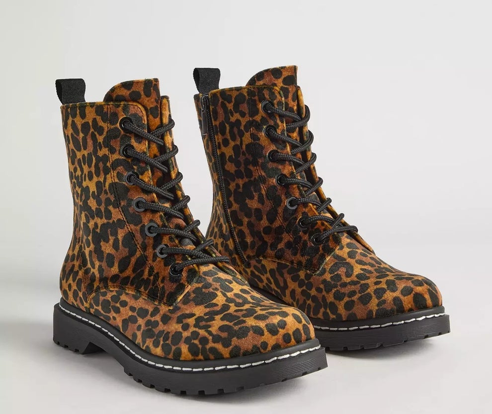 Leopard-print lace-up combat boots with thick soles displayed on a plain background