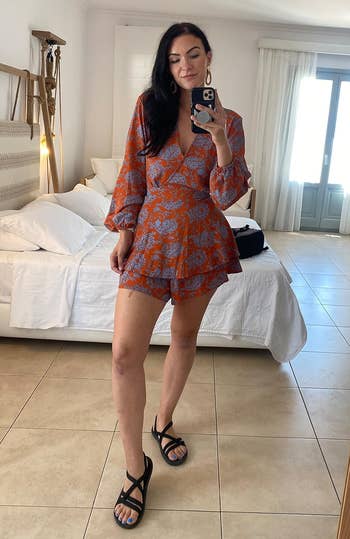 reviewer wearing the black sandals with a cute outfit
