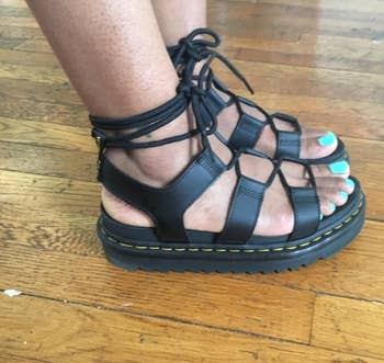 Reviewer's photo wearing sandals while standing