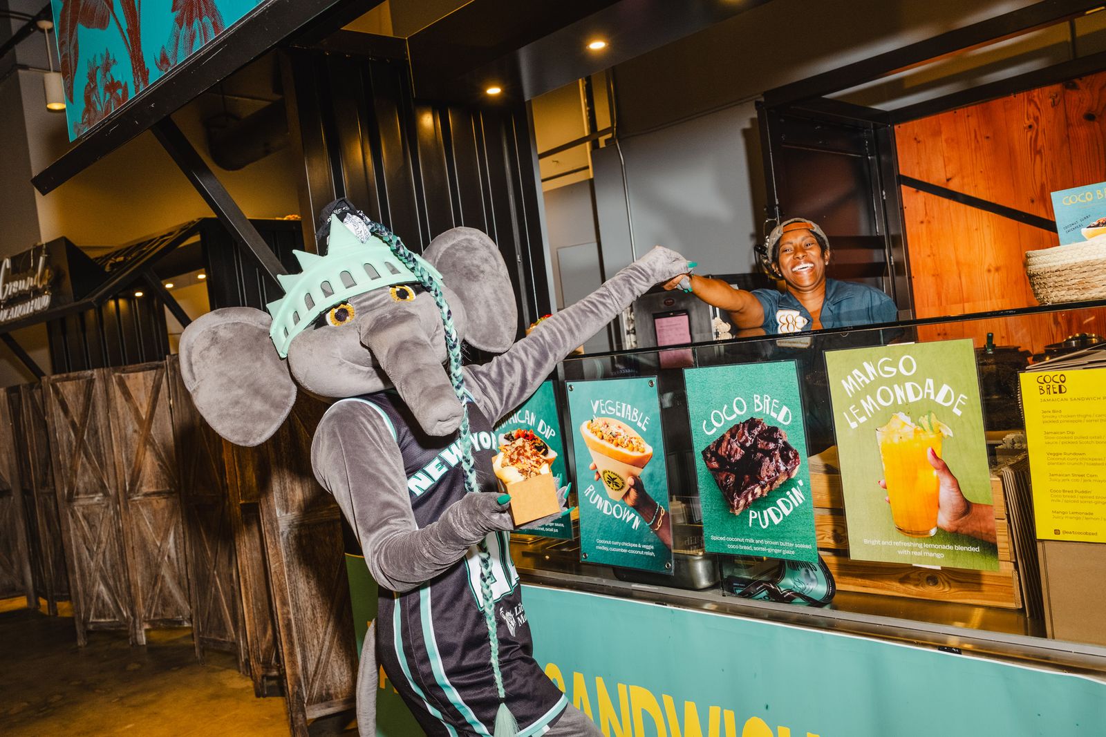 Ellie the mascot standing with the Owner of Coco Bread