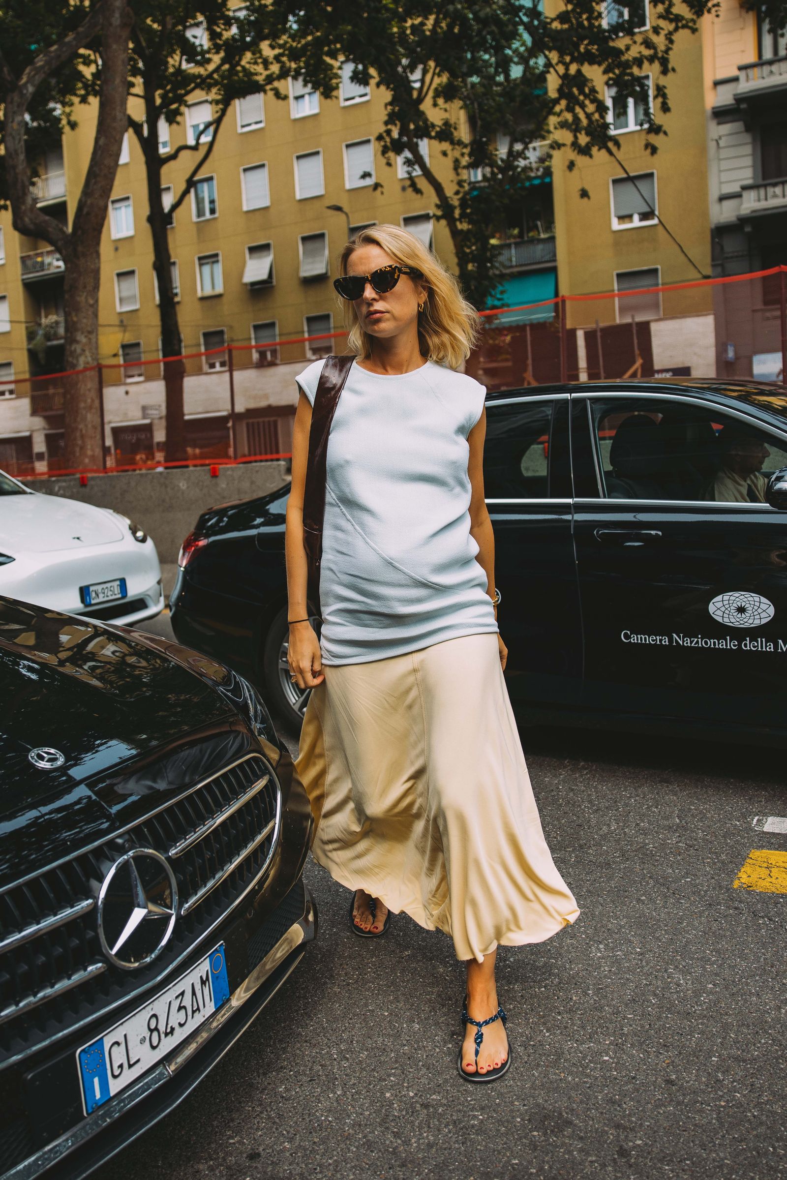 Image may contain Ann Romney Accessories Glasses Adult Person Clothing Skirt Footwear Sandal and Car