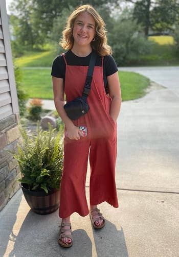 another reviewer wearing rust colored overalls