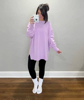 reviewer wearing the white slouch socks with black leggings