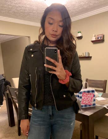 A reviewer wearing the black jacket with jeans