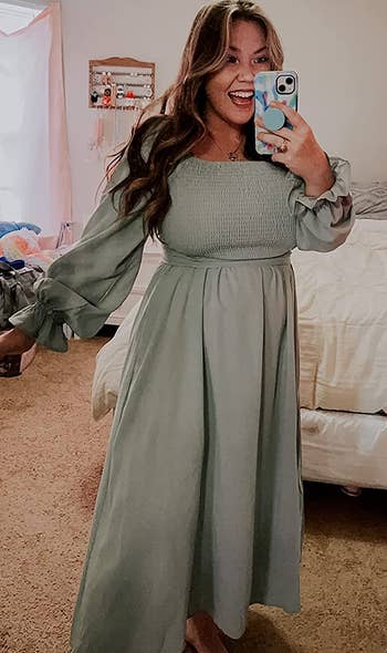 reviewer wearing the green dress with the shirred design in front