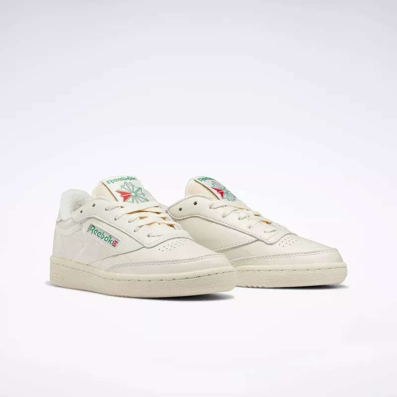 Pair of off-white Reebok sneakers with a retro design and subtle logos