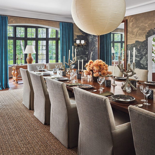 a dining room with a chandelier over the dining table