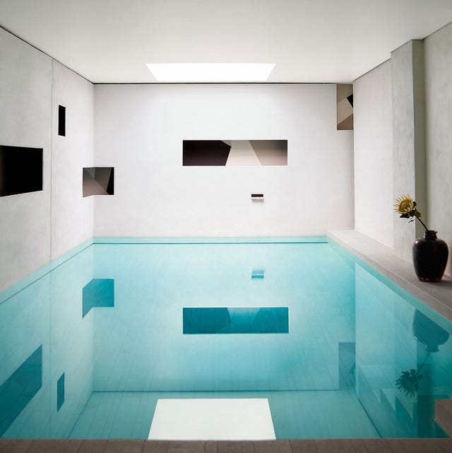 a blue swimming pool in a modernist room