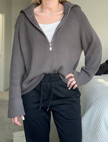 a reviewer wearing the sweater. in gray 