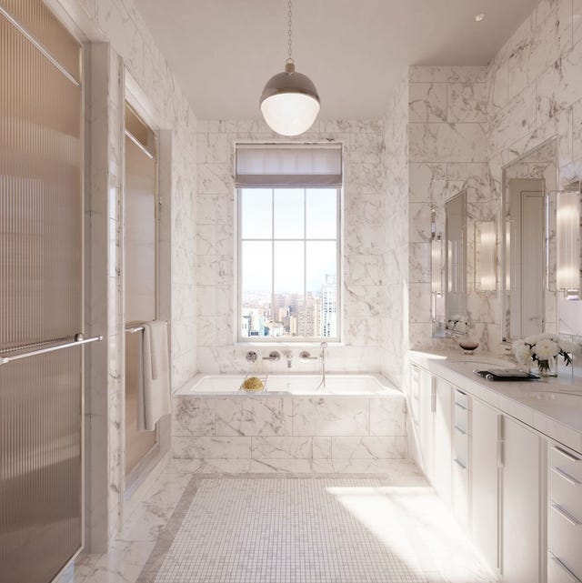 a white marble bathroom with a large window