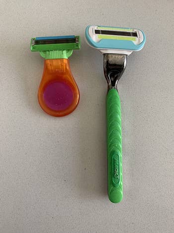 Two razors: one with an orange, round handle and the other with a green, textured handle, suitable for personal grooming