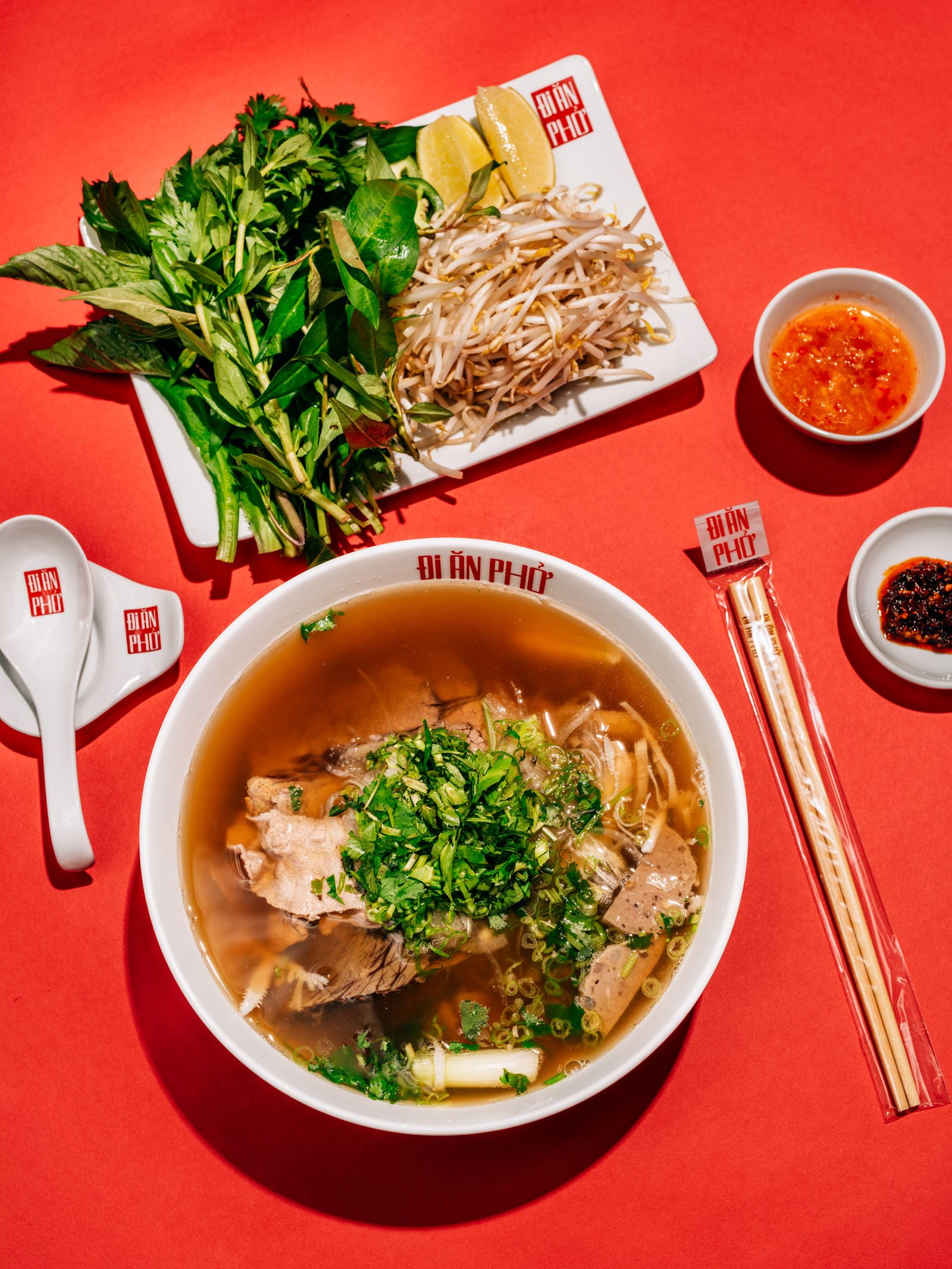 L The pho at Di An Pho comes with the usual fresh herbs and bean sprouts that you would expect. R Portrait of Chef Tran...