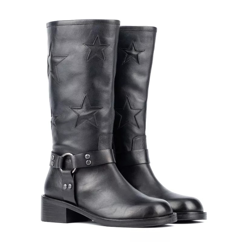 Black mid-calf moto boots with embossed star designs and a decorative buckle strap around the ankle