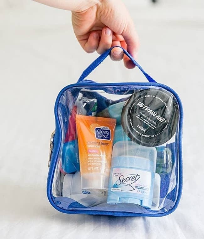 hand holding the blue see-through bag