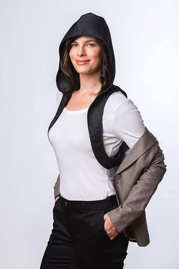 the model with a jacket open, showing how the hood goes under the arms to attach it