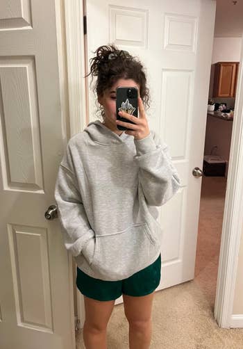 reviewer wearing hoodie in marled gray 