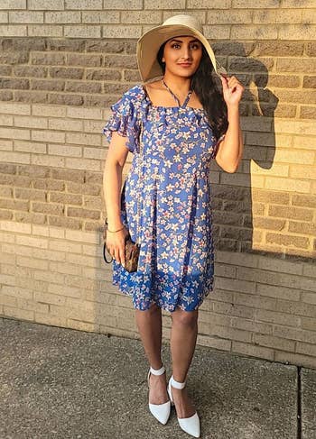 reviewer wearing the white pumps with a dress