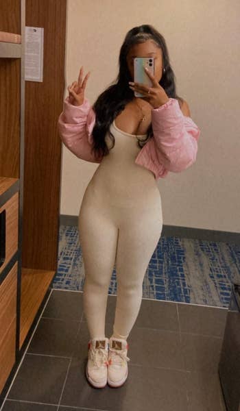 reviewer in white bodysuit 