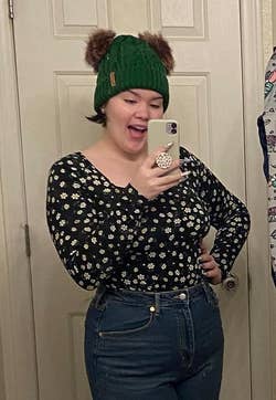 Reviewer wearing the long sleeve bodysuit with a daisy print on it