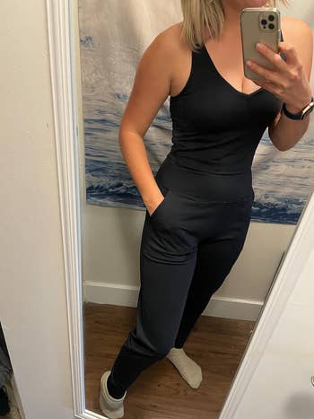 reviewer taking a mirror picture while wearing the black joggers