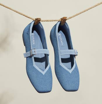 Two knitted-texture Mary Jane shoes with a singular strap are hanging from a clothesline, suitable for casual wear